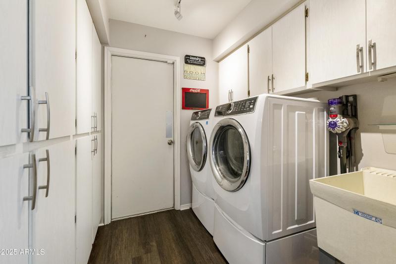 Laundry with cabinets and sink