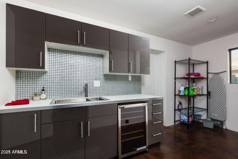 Laundry room with sink and wine fridge