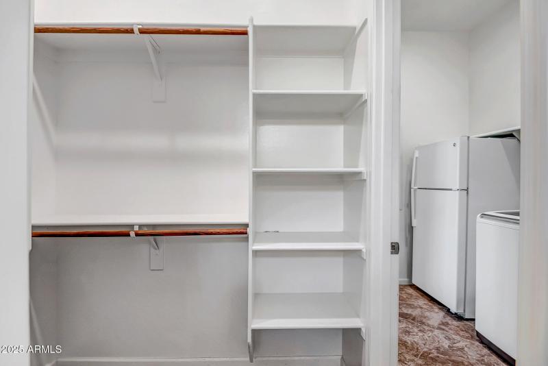 PRIMARY WALKIN CLOSET WITH ACCESS TO UTI