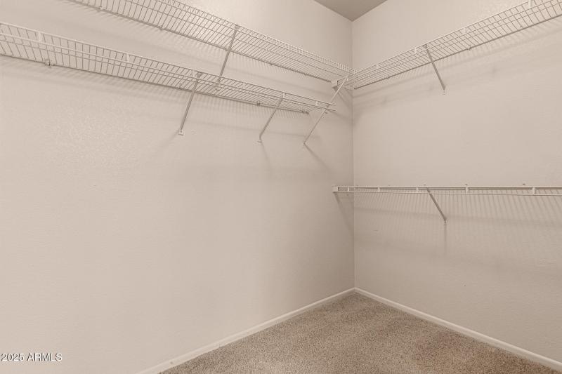 Primary bedroom walk in closet