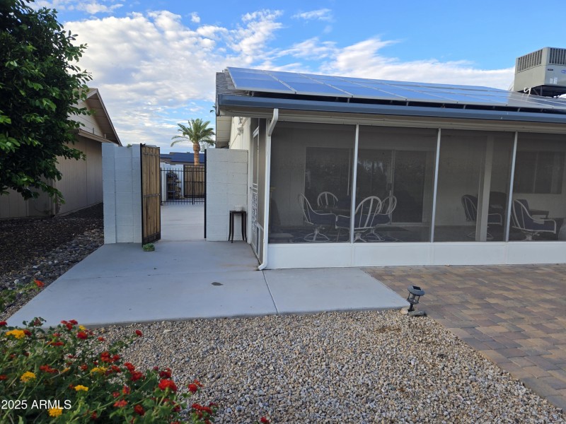 Gated storage / patio pad on west side