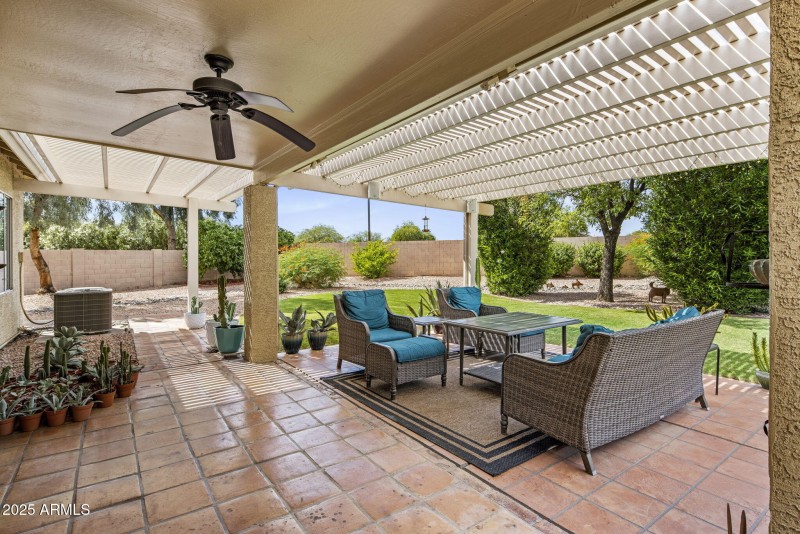 Covered patio and grassy yard