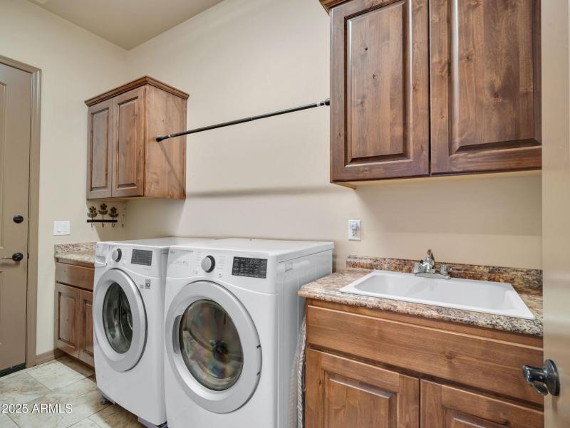 Laundry with sink and cabinets