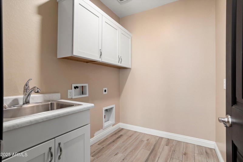 Laundry has cabinets & sink