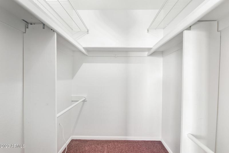 Primary bedroom walk in closet