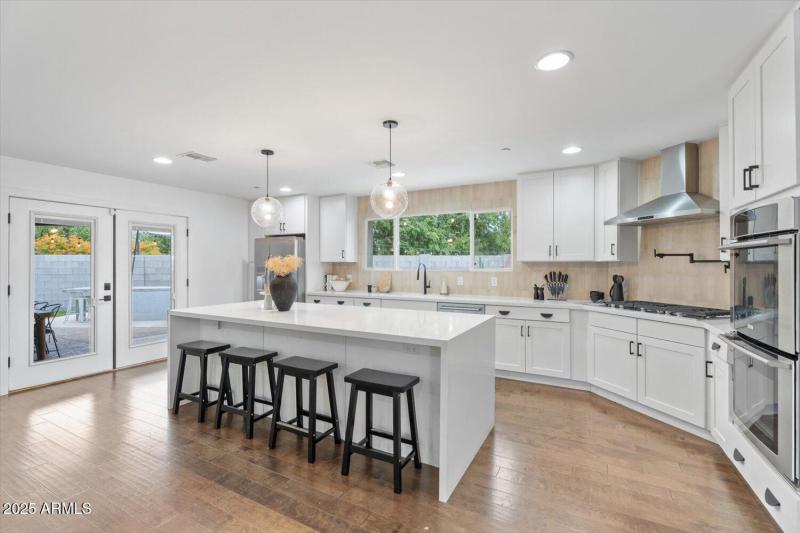 Large island opens to backyard oasis