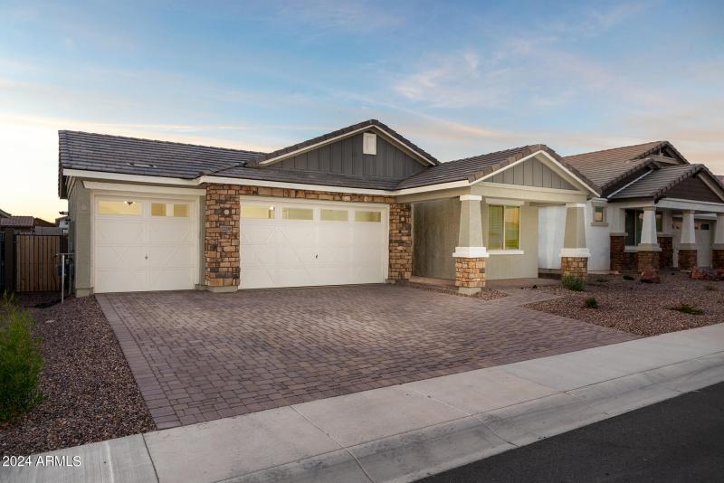 Three car garage with paver driveway