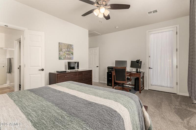 primary bedroom with exit to backyard