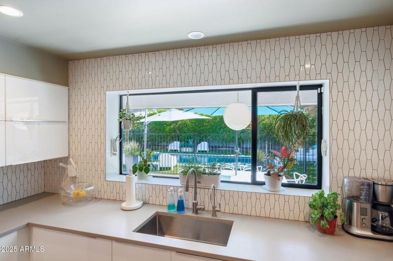 Large picture window overlooks rear yard