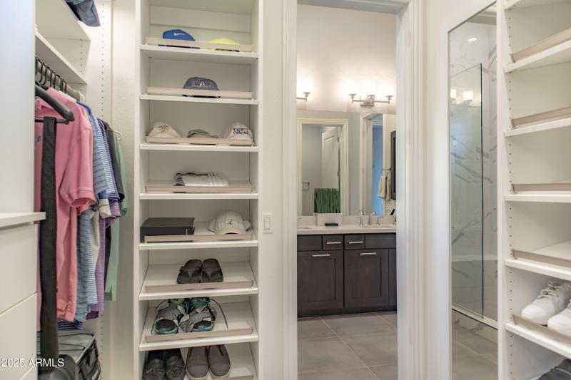 In closet looking out at bath sinks