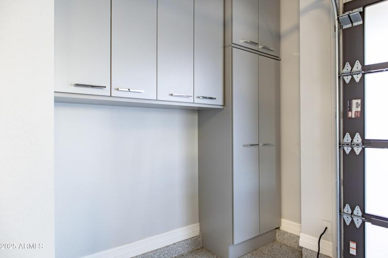 Garage cabinets with trashcan cutout