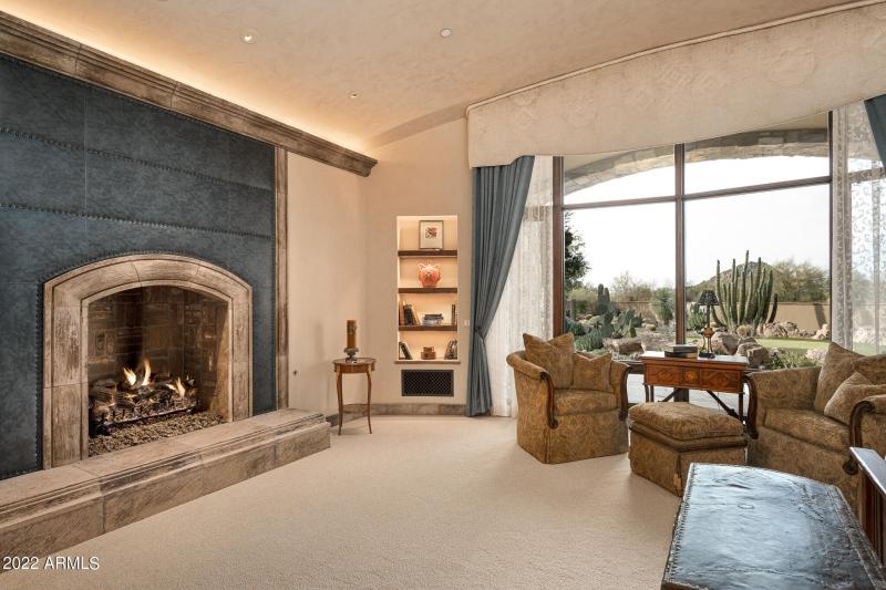 Primary suite leather faced fireplace