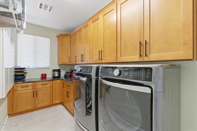 Large laundry area with cabinets