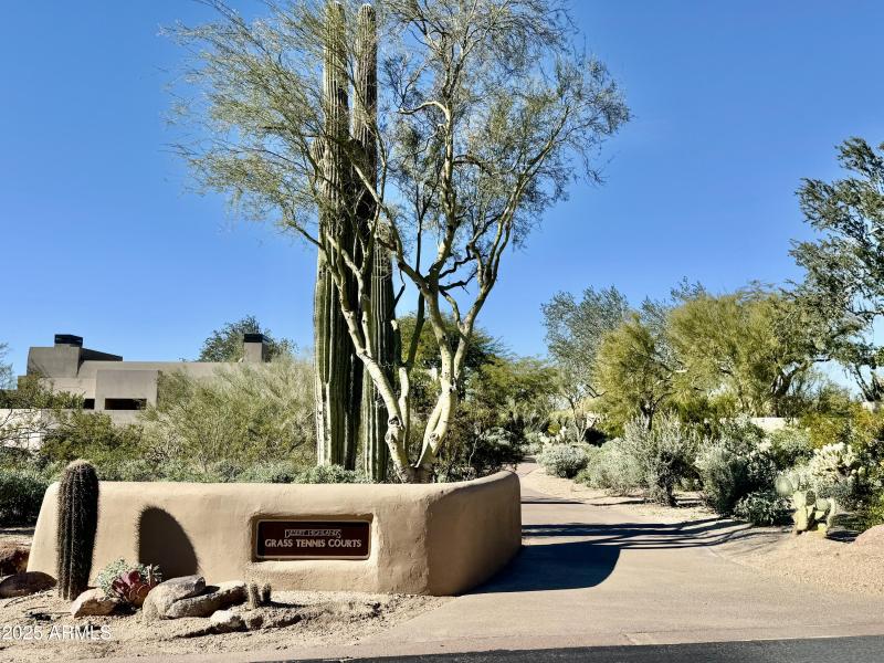 Walk way to double grass tennis courts