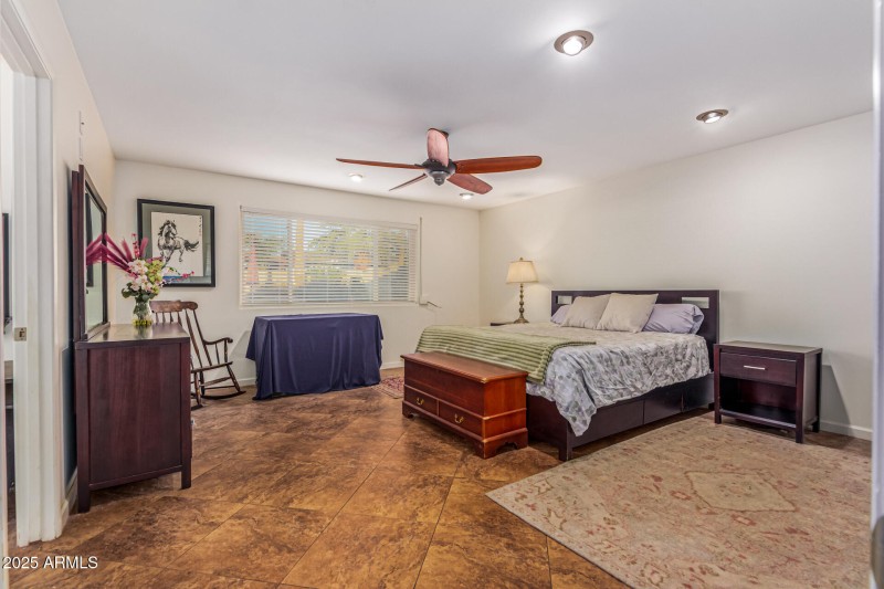 Spacious bedroom with tile floors.
