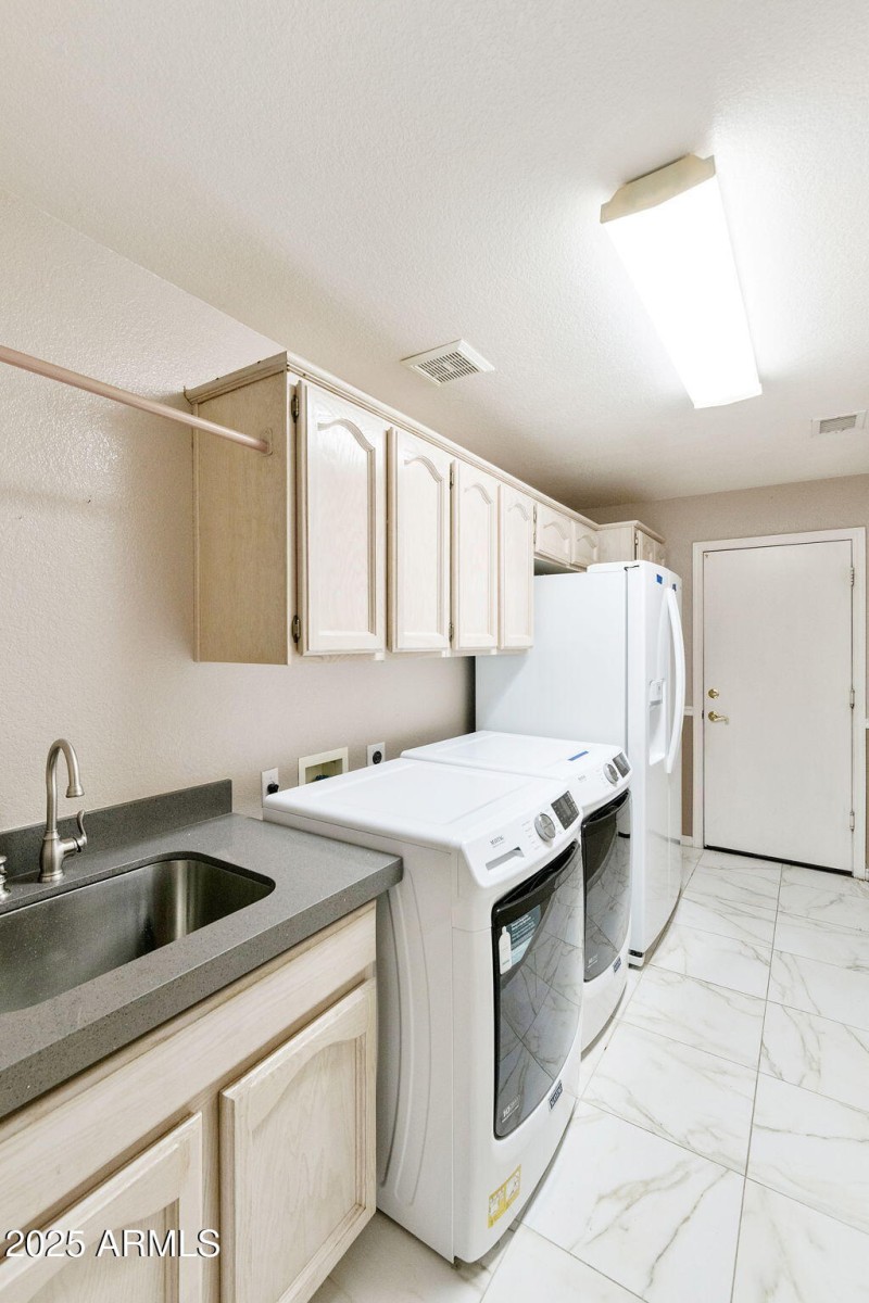 Laundry with sink and cabinets