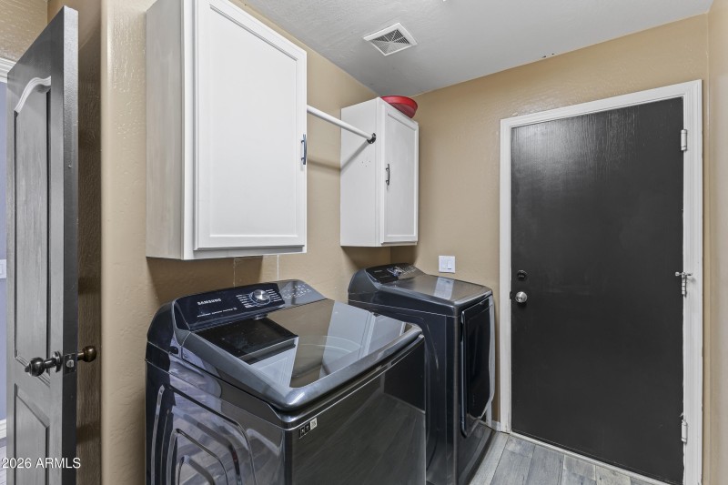 Laundry with cabinets and hanging rod