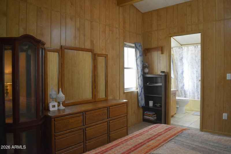 Warm bedroom with oak dresser and mirror