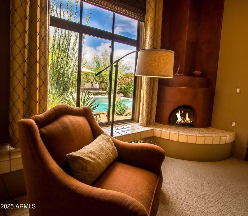 master suite sitting area with pool view