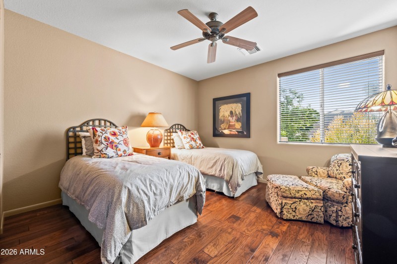 Guest bedroom with wood floors