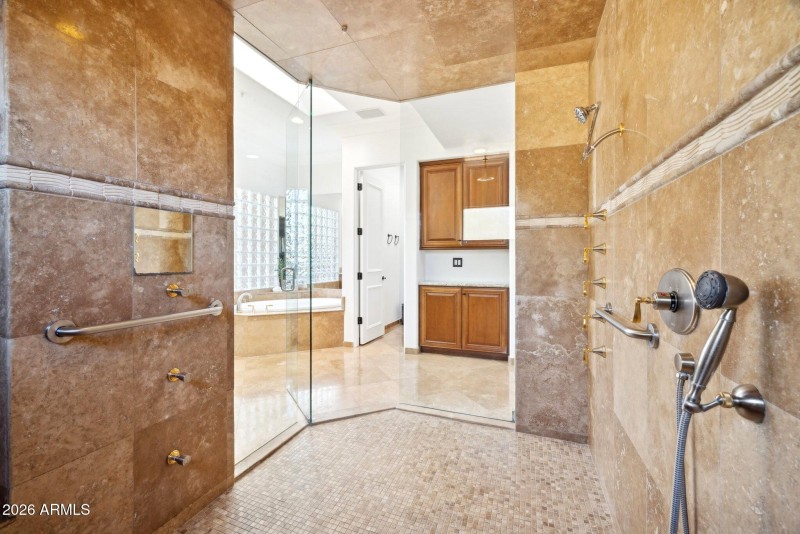 Glass enclosed travertine shower