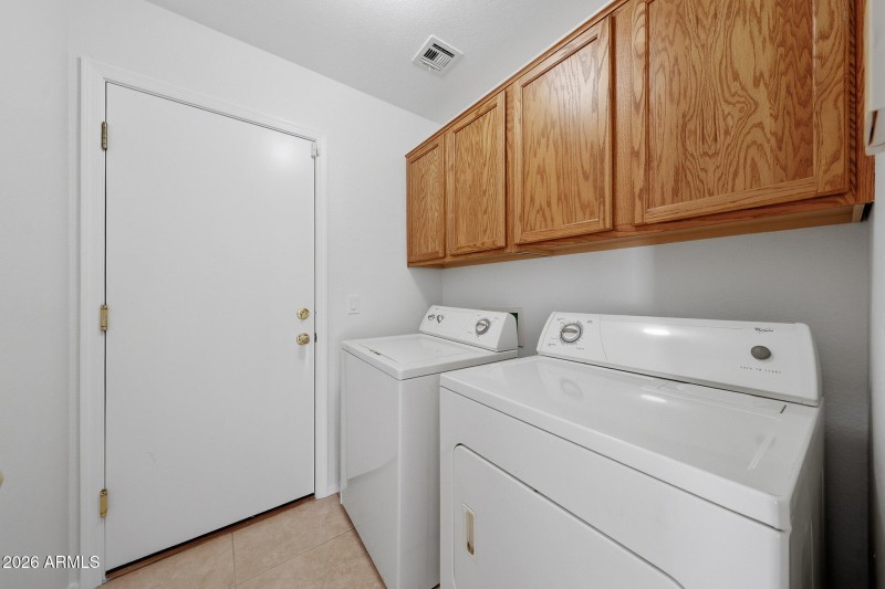 Inside laundry with cabinets