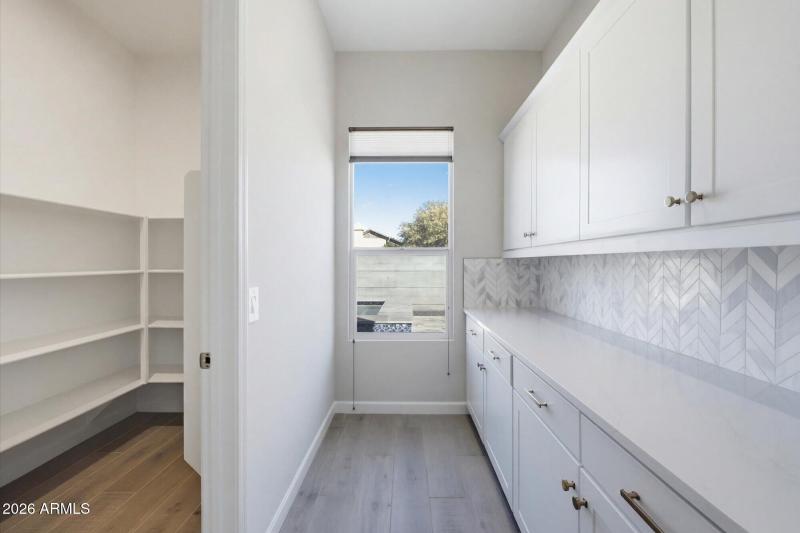 Spacious Walk In Pantry w Custom Shelves