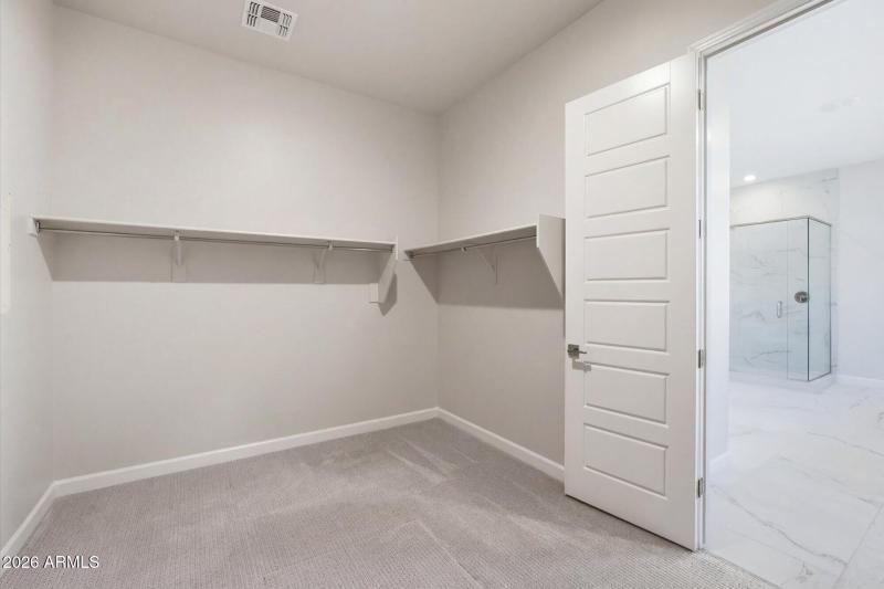 Primary Walk-In Closet w Custom Shelves