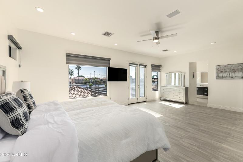 Upstairs primary bedroom with balcony