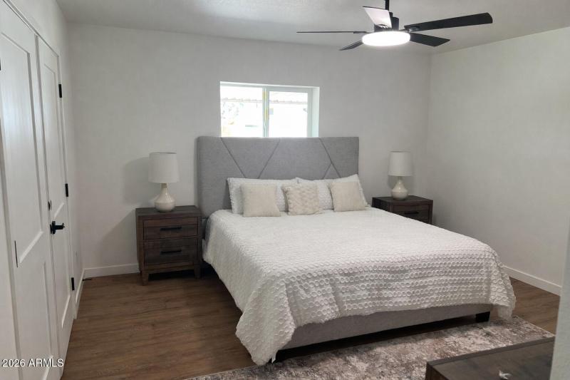 Modern bedroom with artistic headboard.