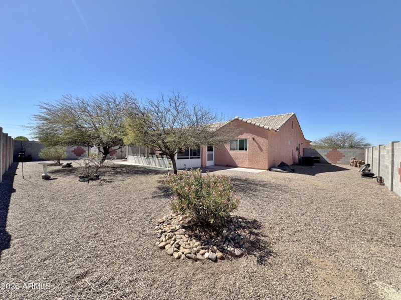 Rear view of home and back yard