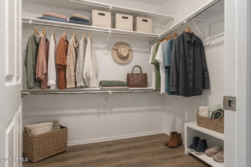 Organized walk-in closet with neutral to