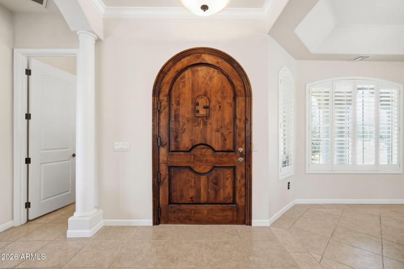 Grand Entry with Custom Arched Wood Door