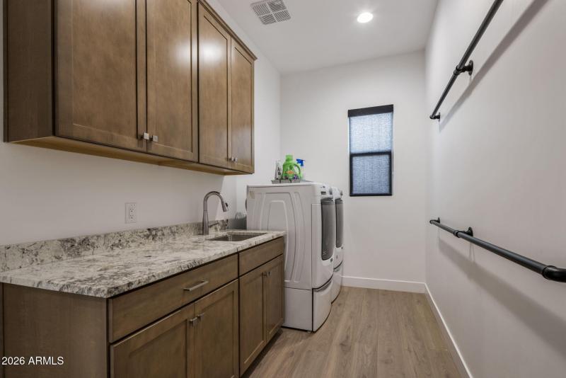 Large Laundry with Cabinetry and Sink